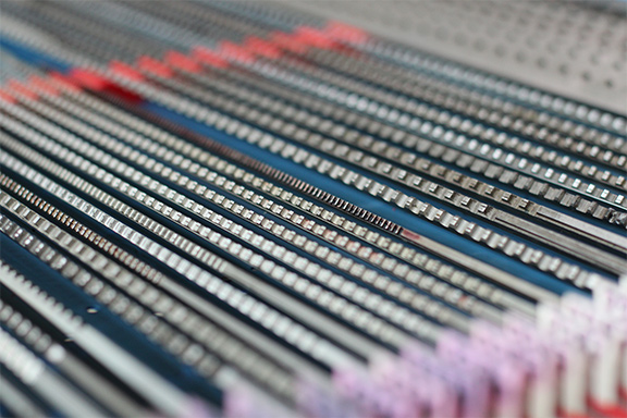 Rack broach batch in production array at United Broach showing tooth rows