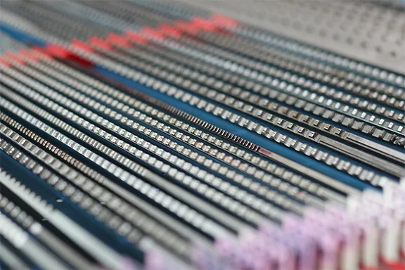 Rack broach batch in production array at United Broach Company showing tooth rows